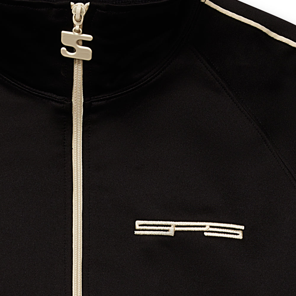 Black poly blend track jacket with full zip, white zipper, SP5 logo, and charm pull.