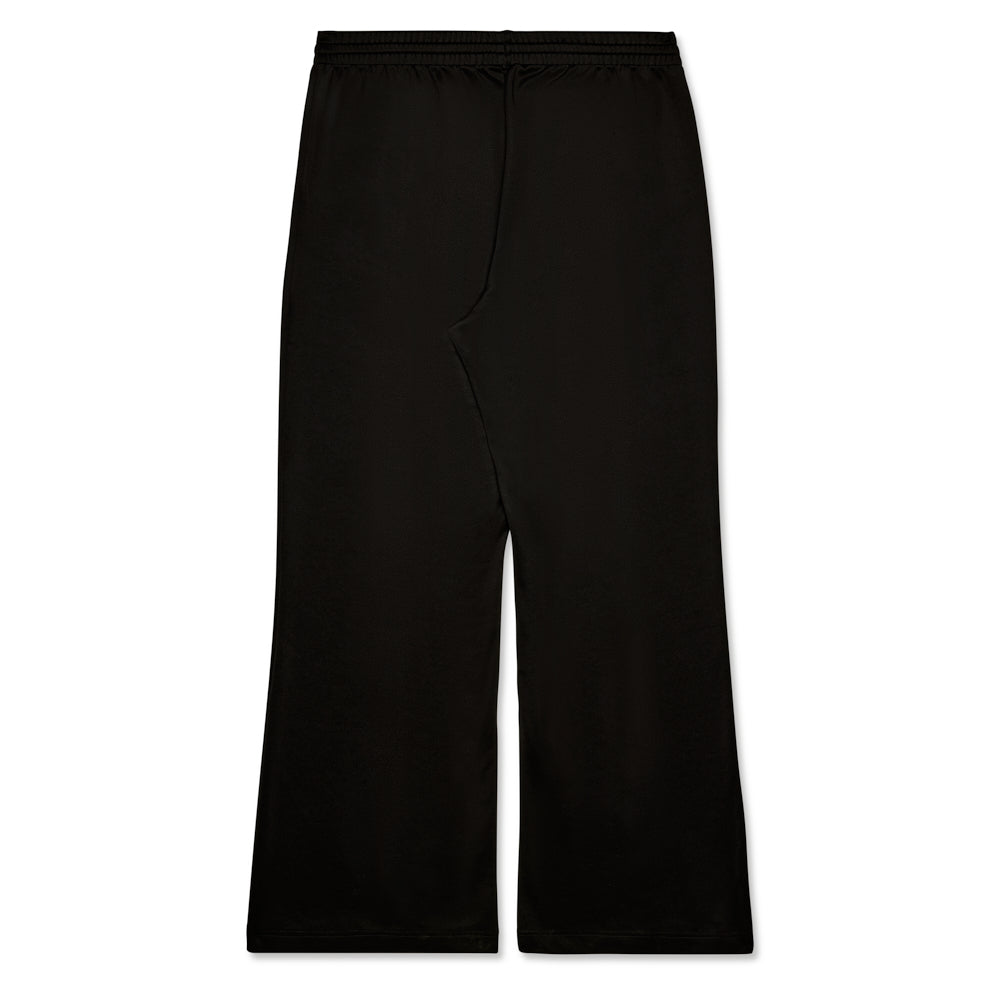 Black poly blend track pant with elasticized waistband and wide leg silhouette.