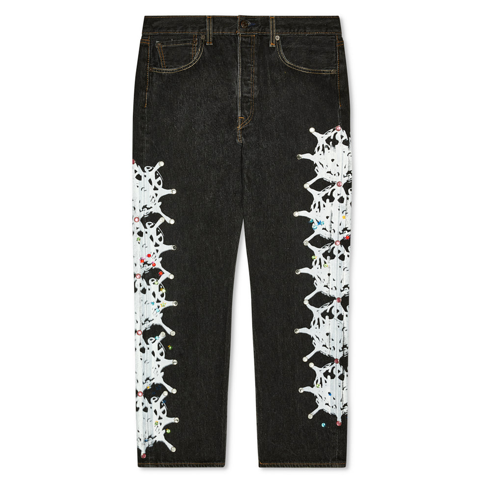 Black vintage denim with white web design and colorful rhinestone embellishments down each leg.