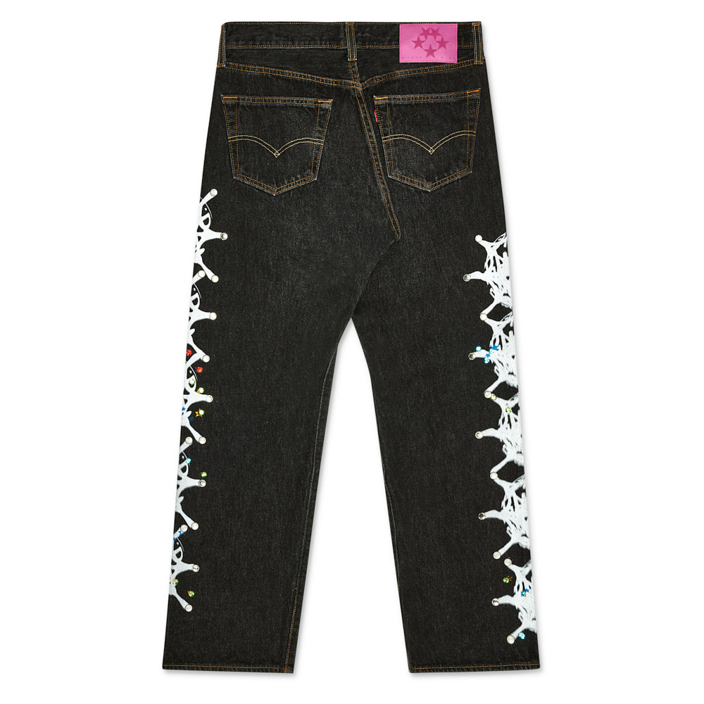 Black vintage Levi's 501 denim with pink SP5DER back tab, white web design, and rhinestone embellishments.