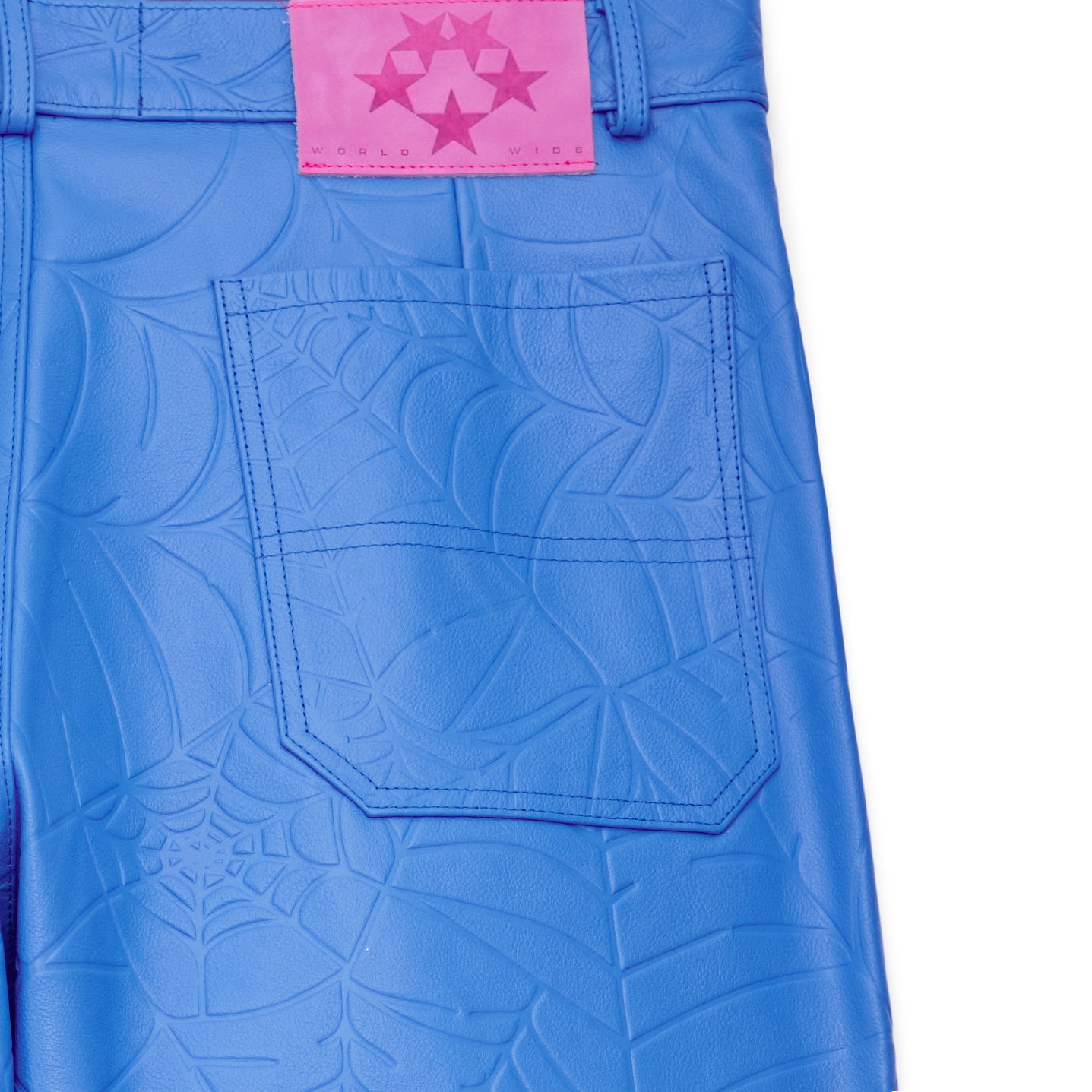 Blue cowskin leather pants with debossed web design and pink suede logo patch.