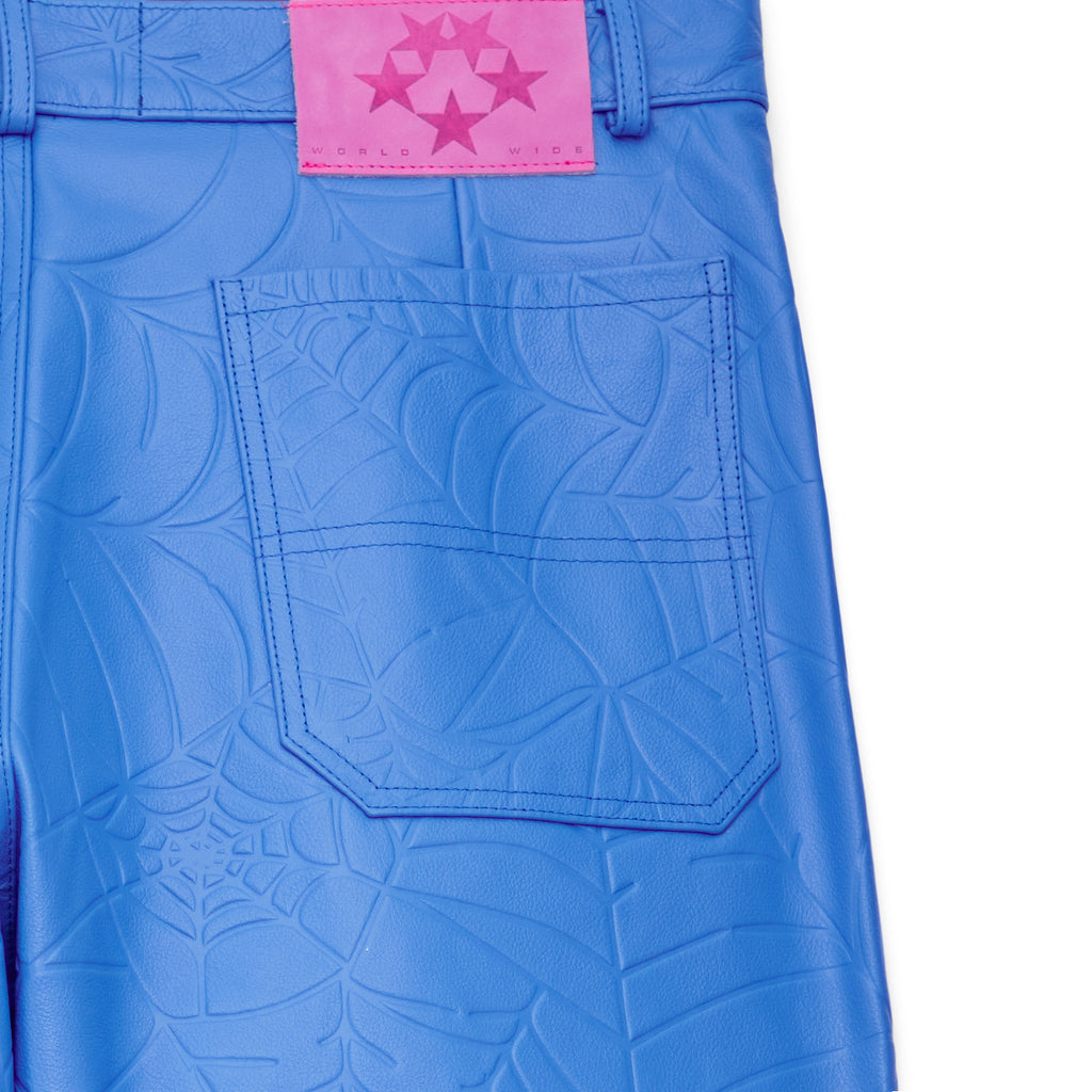 Blue cowskin leather pants with debossed web design and pink suede logo patch.