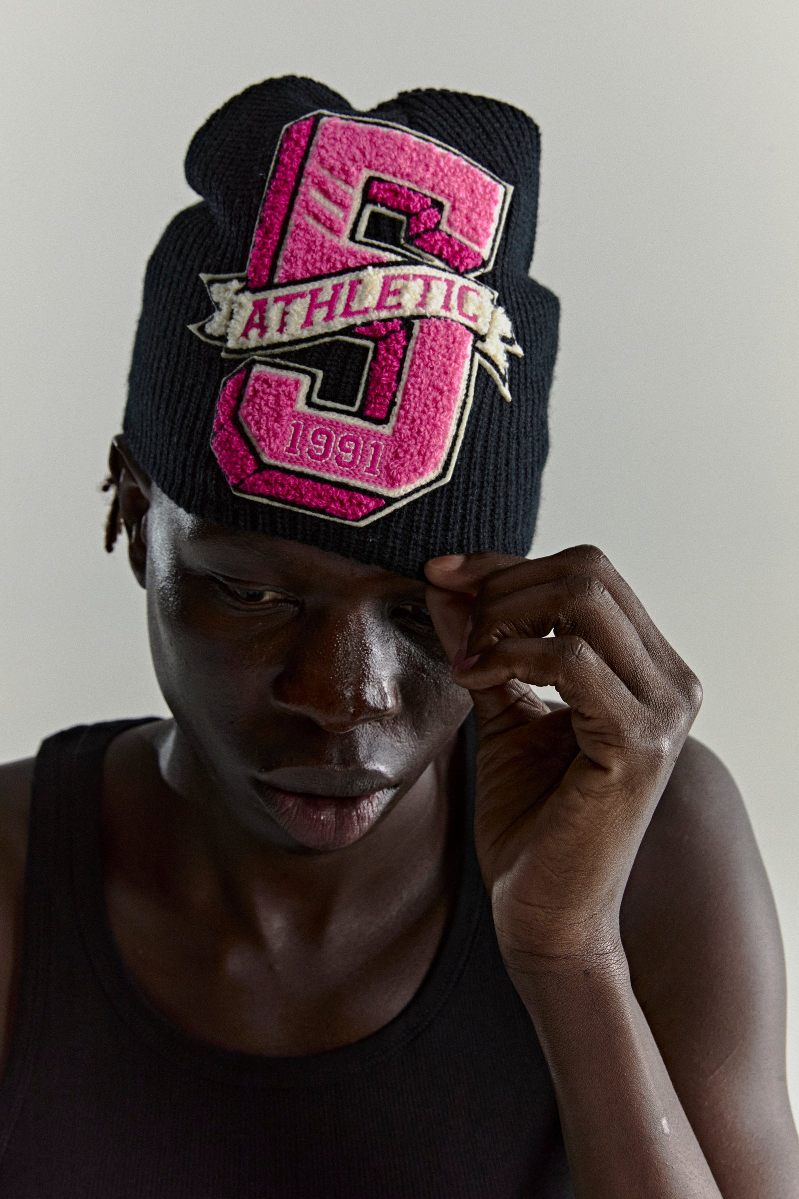 Black knit ribbed beanie with a large pink chenille '5 Athletic 1991' patch.