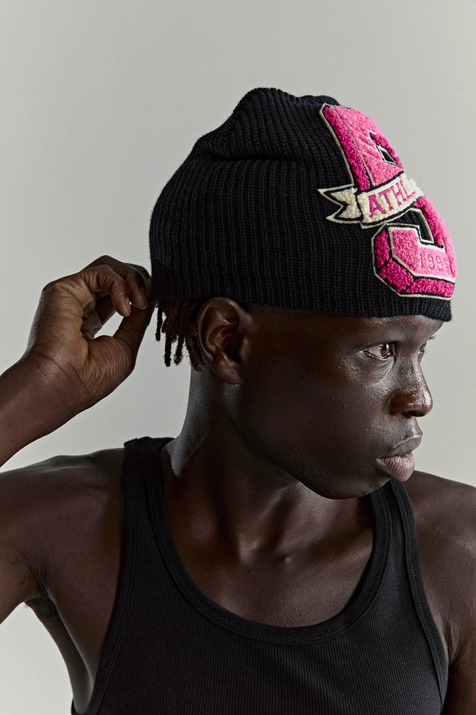 Black knit ribbed beanie with a large pink '5 Athletic' chenille patch on the front.