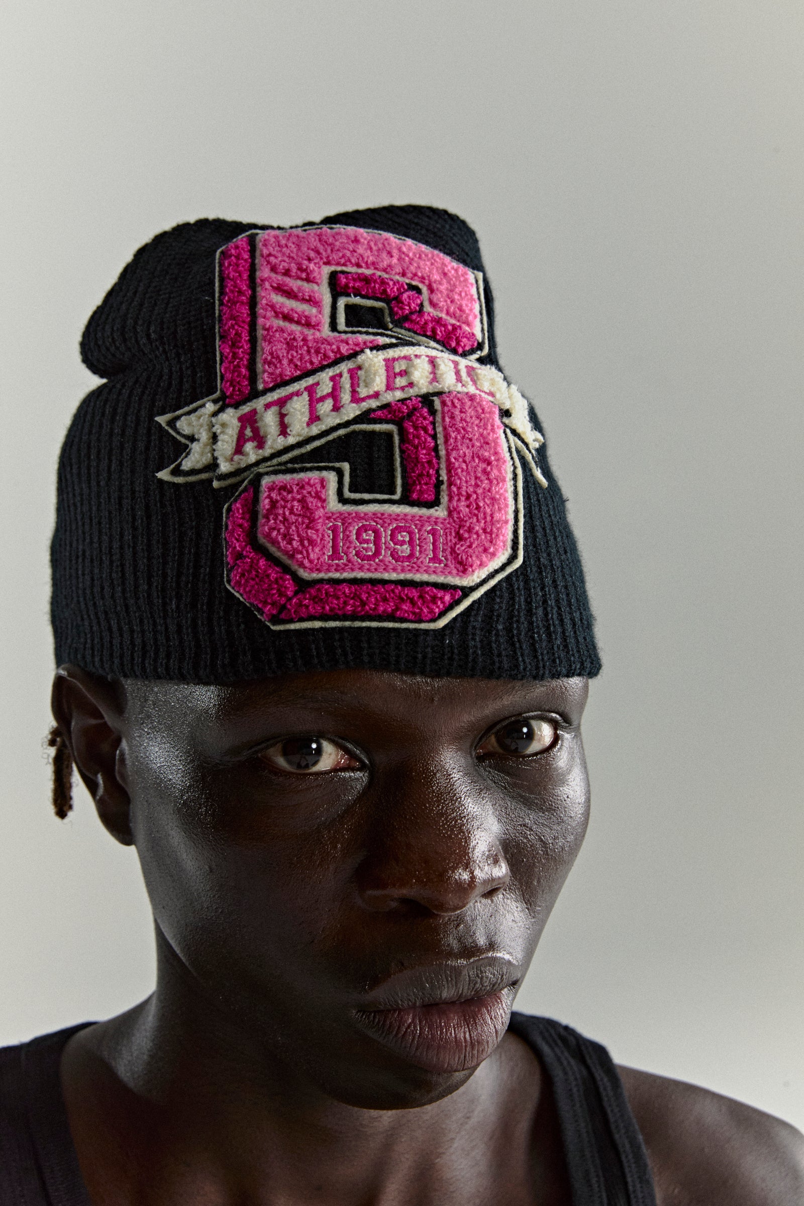 Black knit ribbed beanie with a pink chenille '5 Athletic 1991' patch.