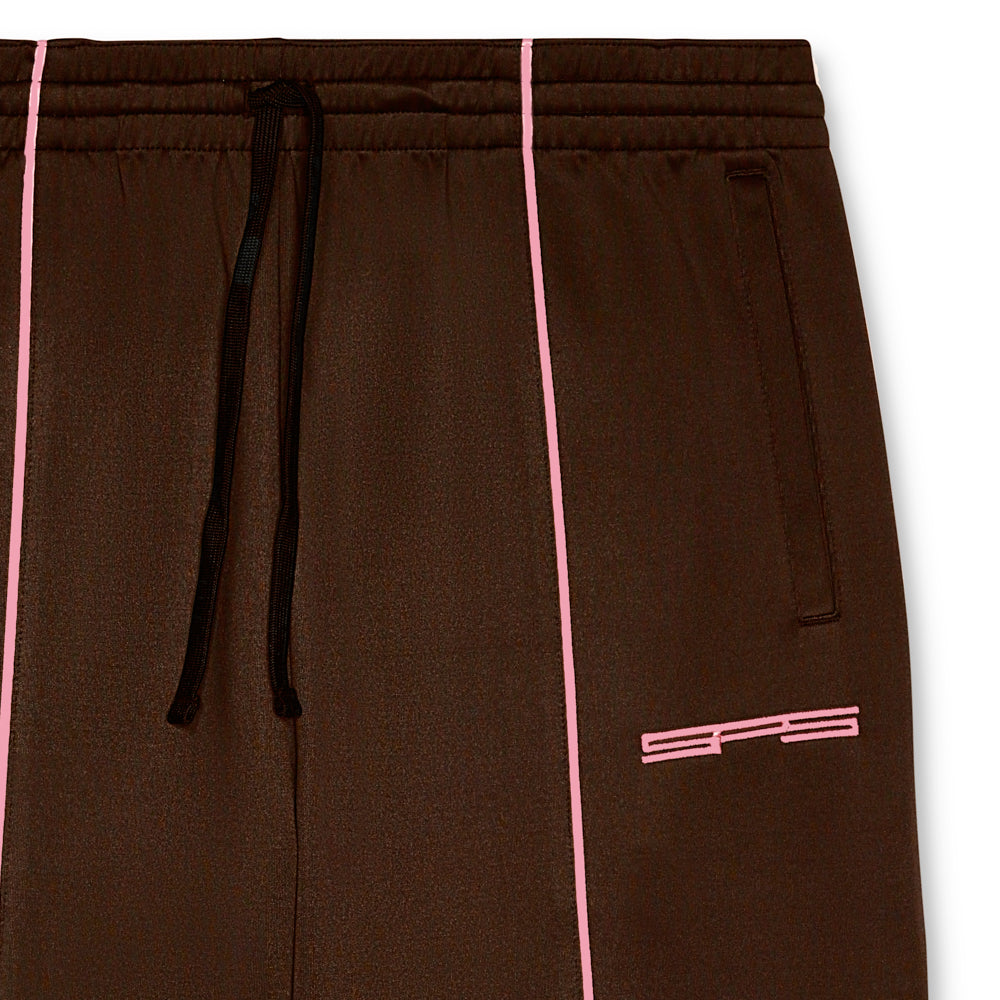 Brown poly blend track pant with pink contrast piping, elasticized waistband, and SP5 logo embroidery.