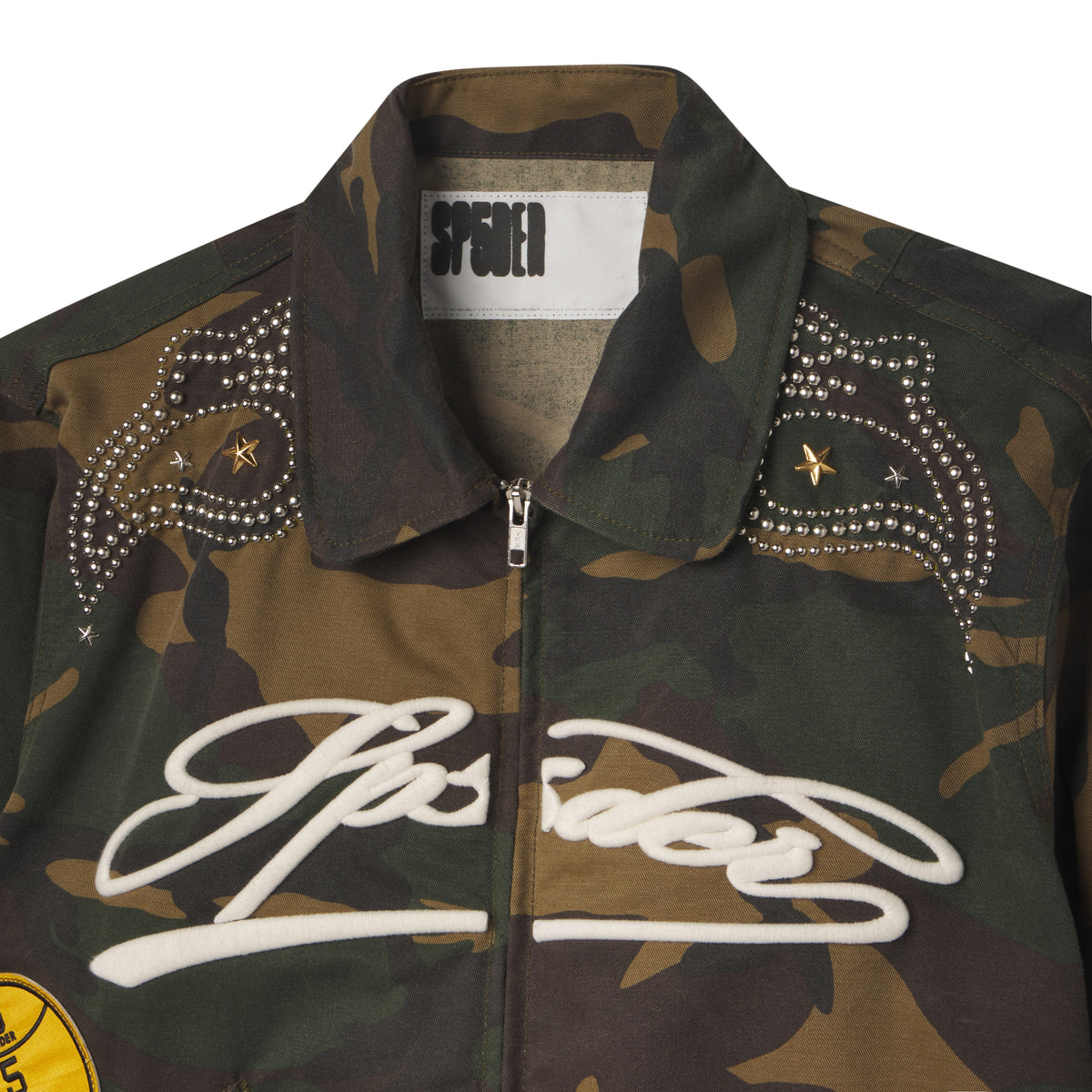 Camo cotton canvas bomber jacket with white embroidered script, studded shoulder detailing, and star accents.