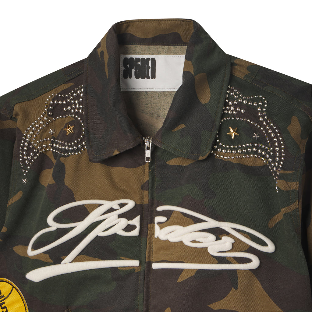 Camo cotton canvas bomber jacket with white embroidered script, studded shoulder detailing, and star accents.