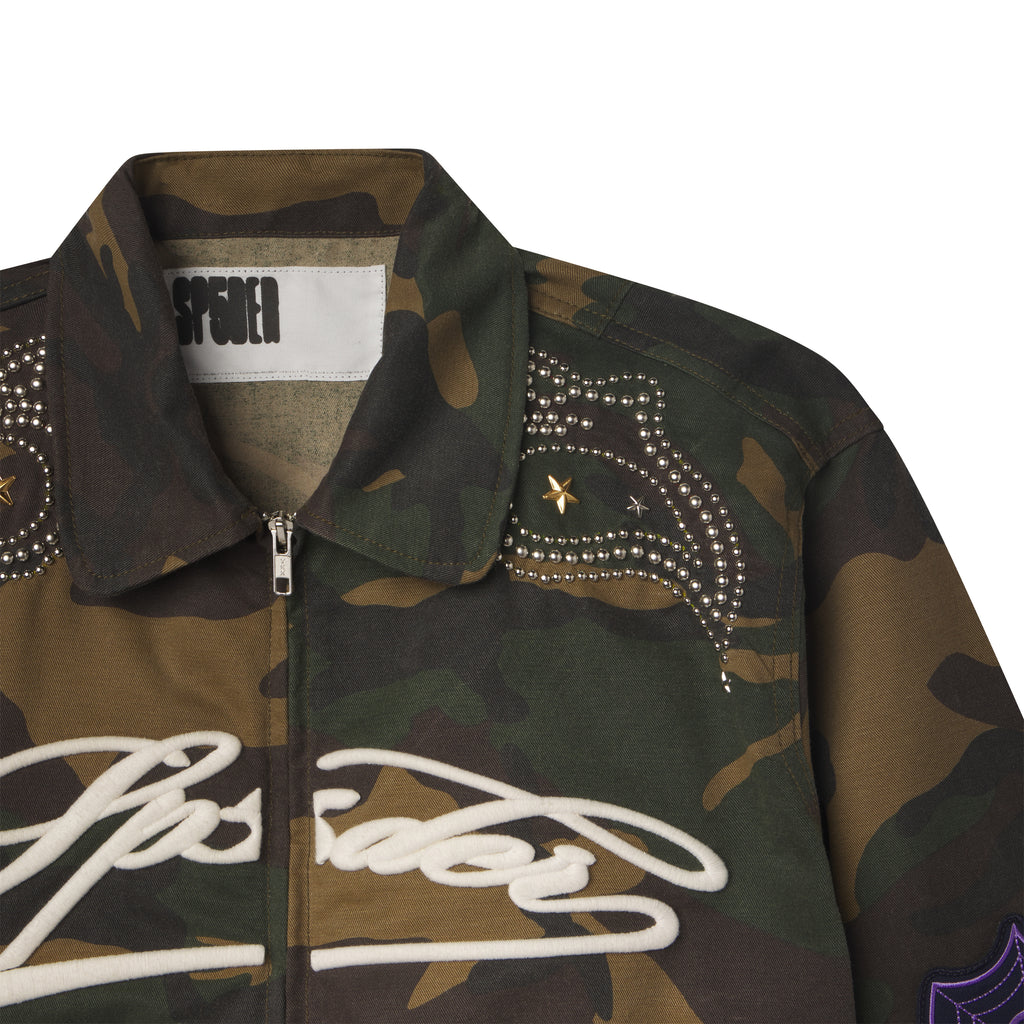 Camo cotton canvas bomber jacket with embroidered white script, studded shoulder detailing, and a spread collar.