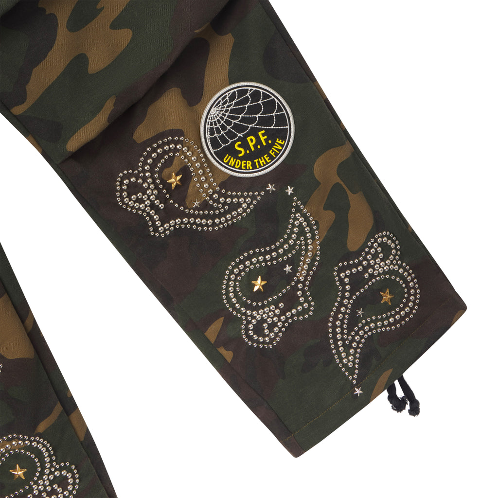 Camo cotton canvas cargo pants featuring embroidered graphic patches, studded paisley designs, and star accents.