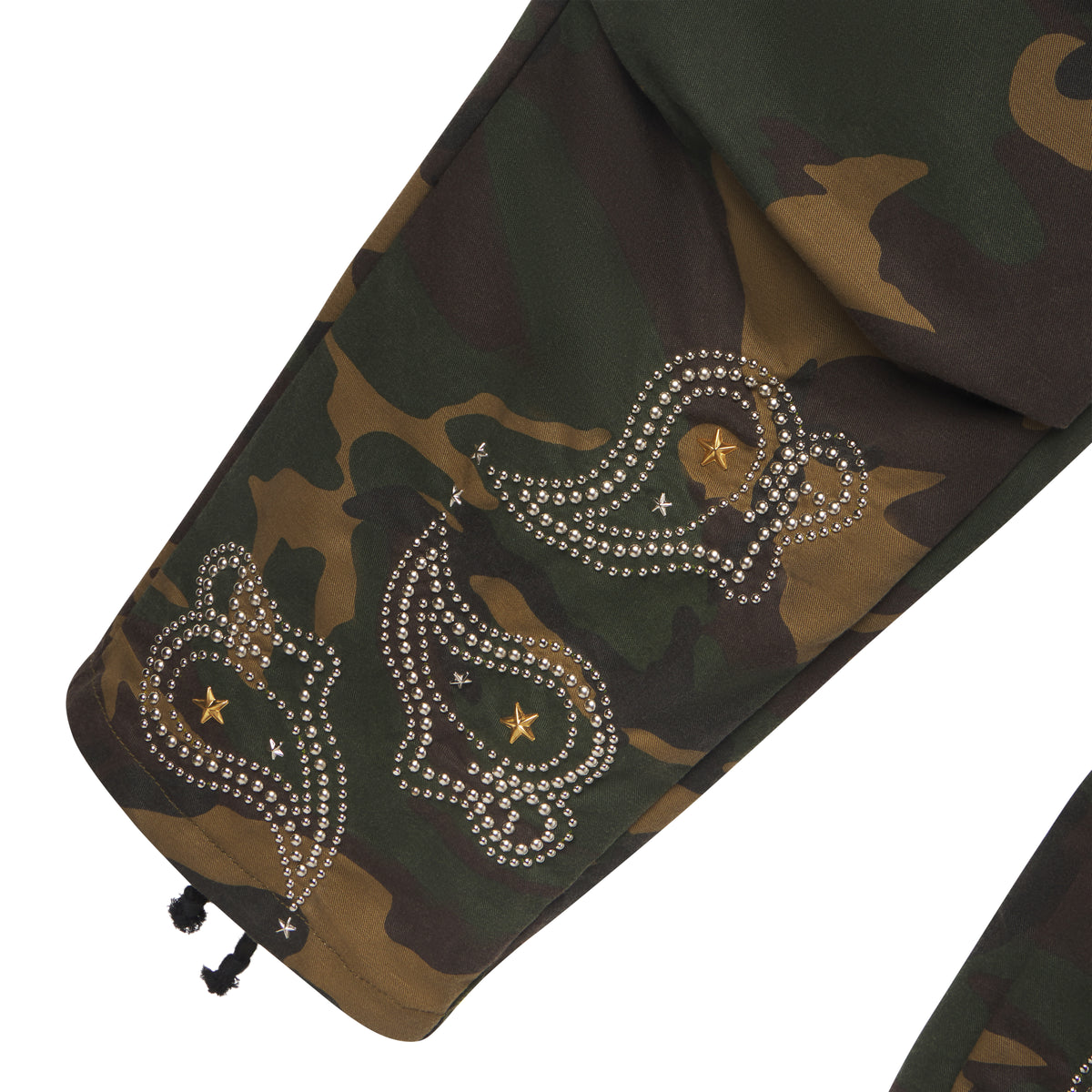 Cotton canvas camo cargo pants featuring intricate studded paisley graphic designs and gold star accents at the hem.