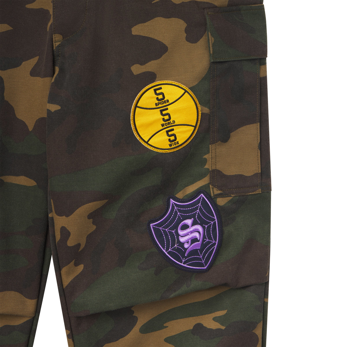 Cotton canvas camo cargo pants featuring yellow basketball and purple spiderweb graphic patches.