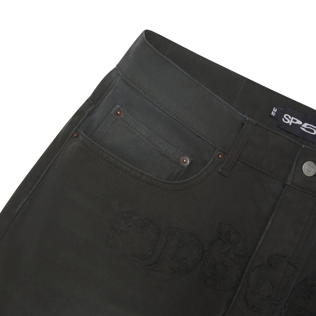 Faded black 13oz denim pants with a frayed SP5DER graphic logo, branded hardware, and a leather back patch.