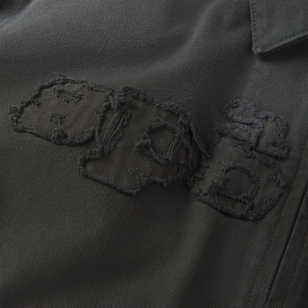 Charcoal 13oz canvas work jacket featuring a distressed, frayed SP5DER graphic logo embroidered on the chest.