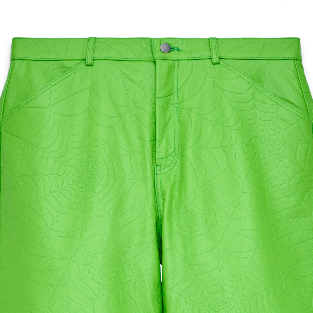 Lime green cowskin leather pants with debossed web design, button fly, and belt loops.
