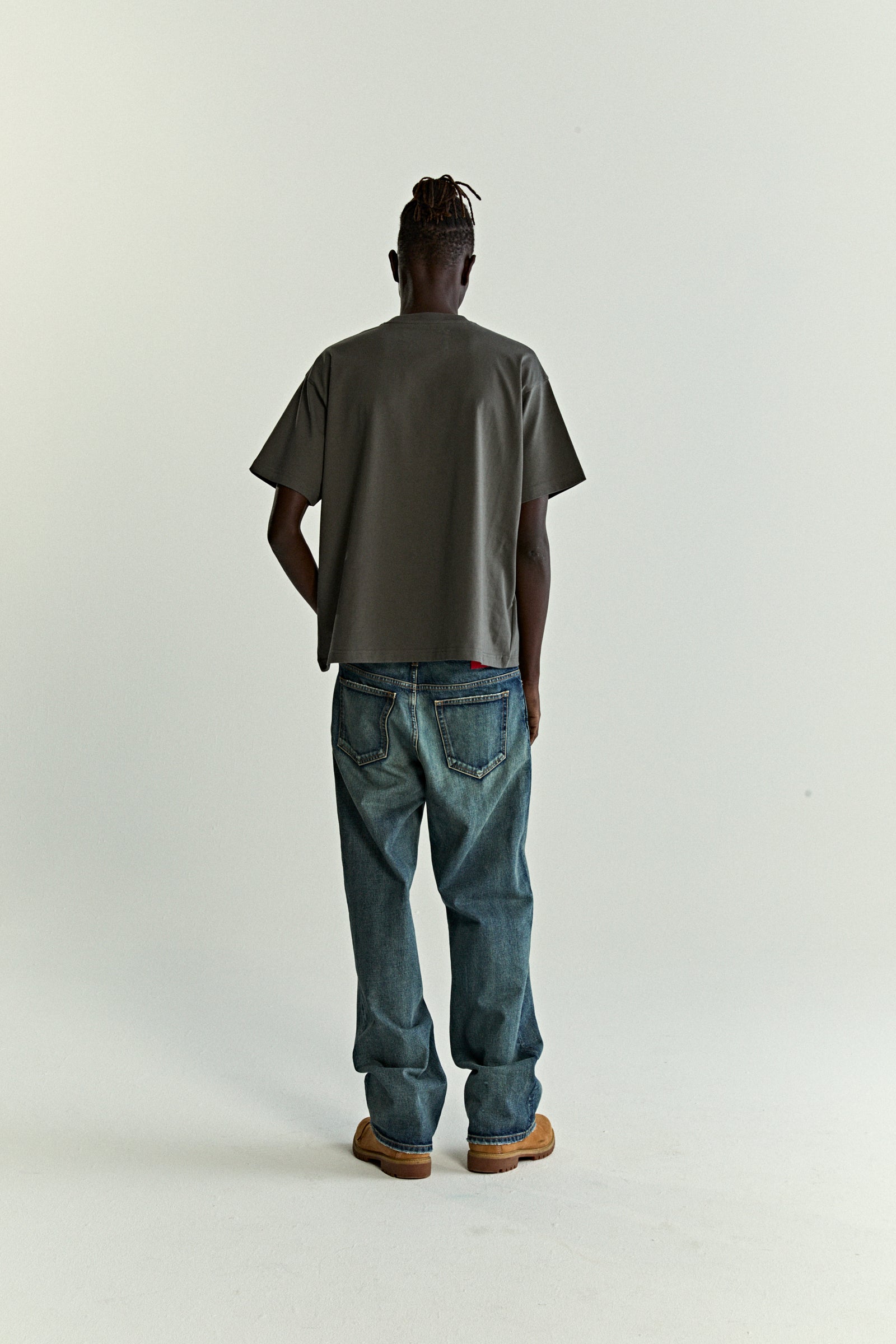 Man from behind wearing a charcoal gray, standard fit, 100% cotton OG WEB V2 TEE.