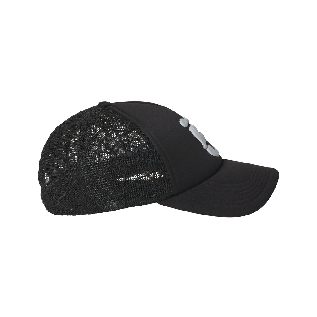 Black trucker hat with a curved brim, puff print logo, and embroidered web mesh side panels.