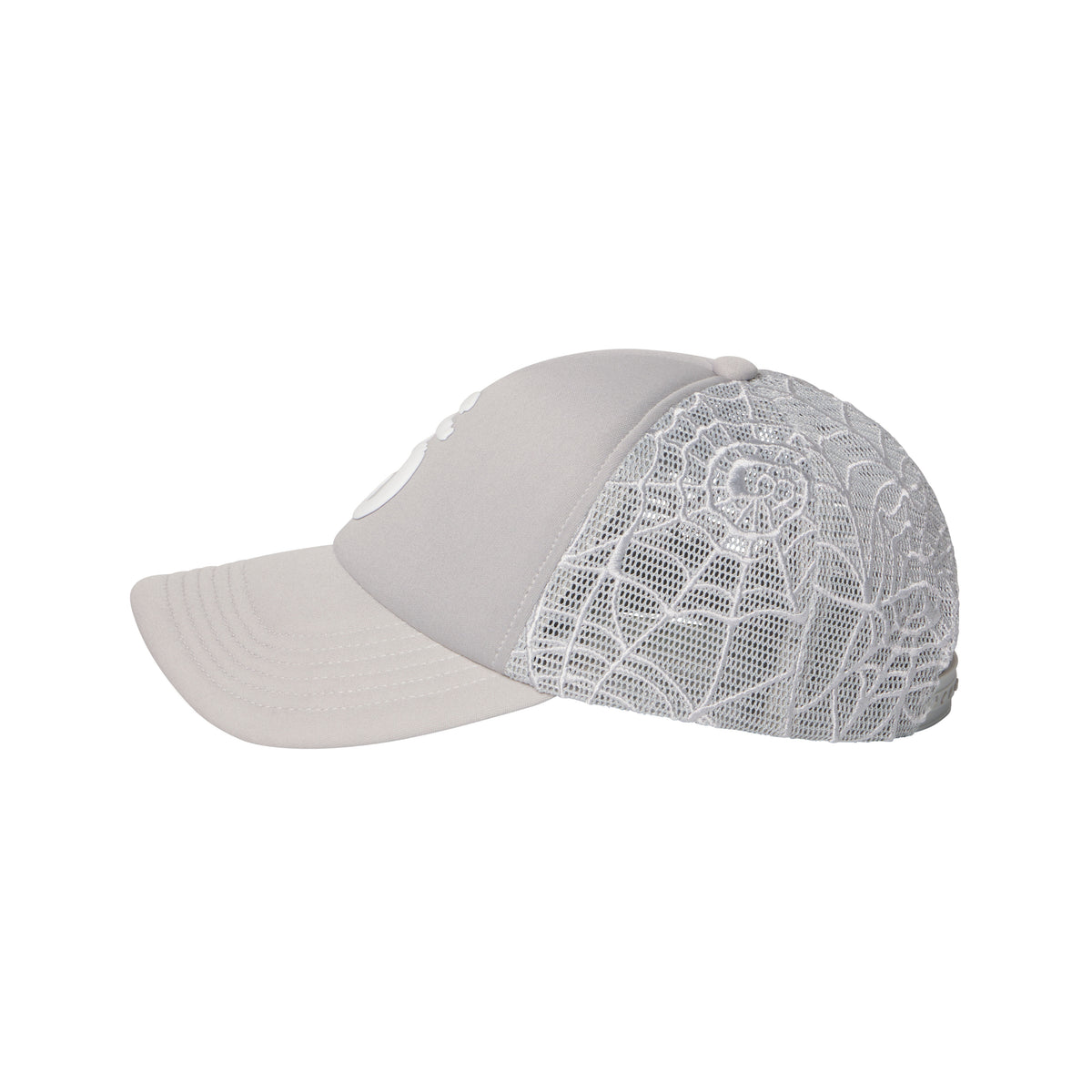 Light grey trucker hat with a curved brim, puff print logo, and intricate white embroidered web mesh side panels.