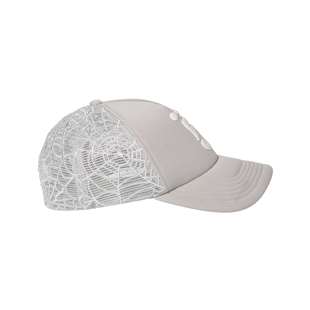Light grey trucker hat with a white puff print logo, curved brim, and intricate embroidered web mesh side panels.