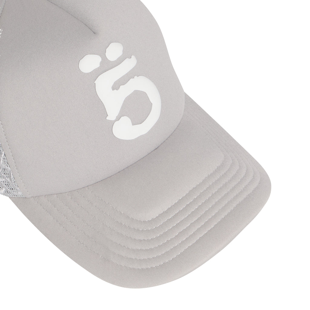 Light grey mesh trucker hat featuring a white puff print graphic design on the front and a curved brim.