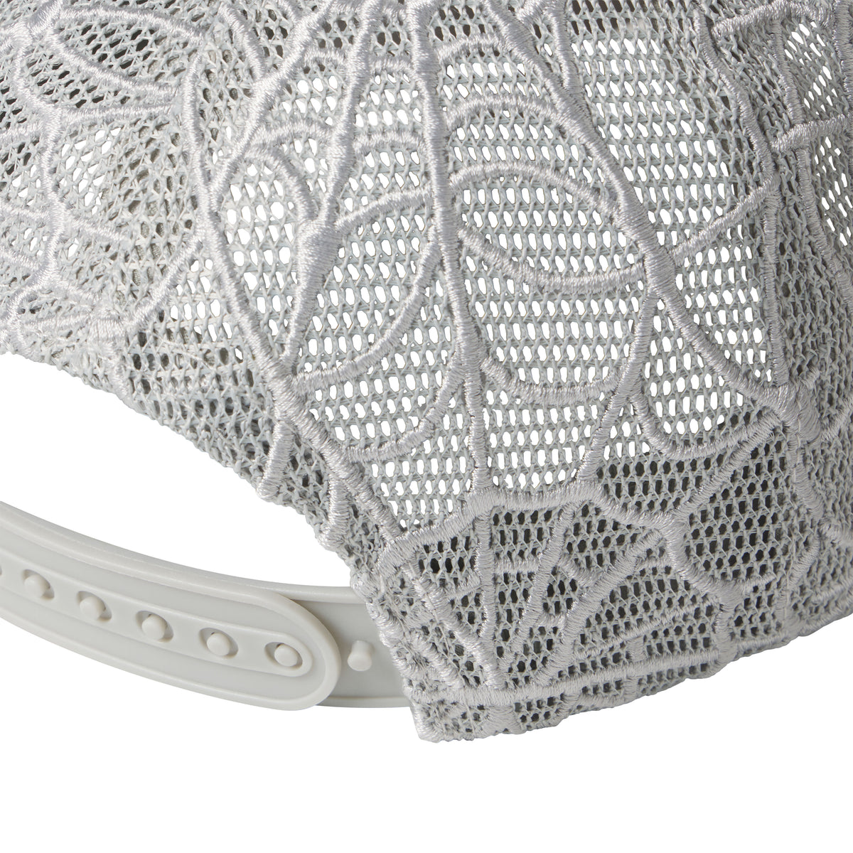 Grey trucker hat featuring intricate web-patterned embroidery on mesh panels and an adjustable plastic snapback closure.