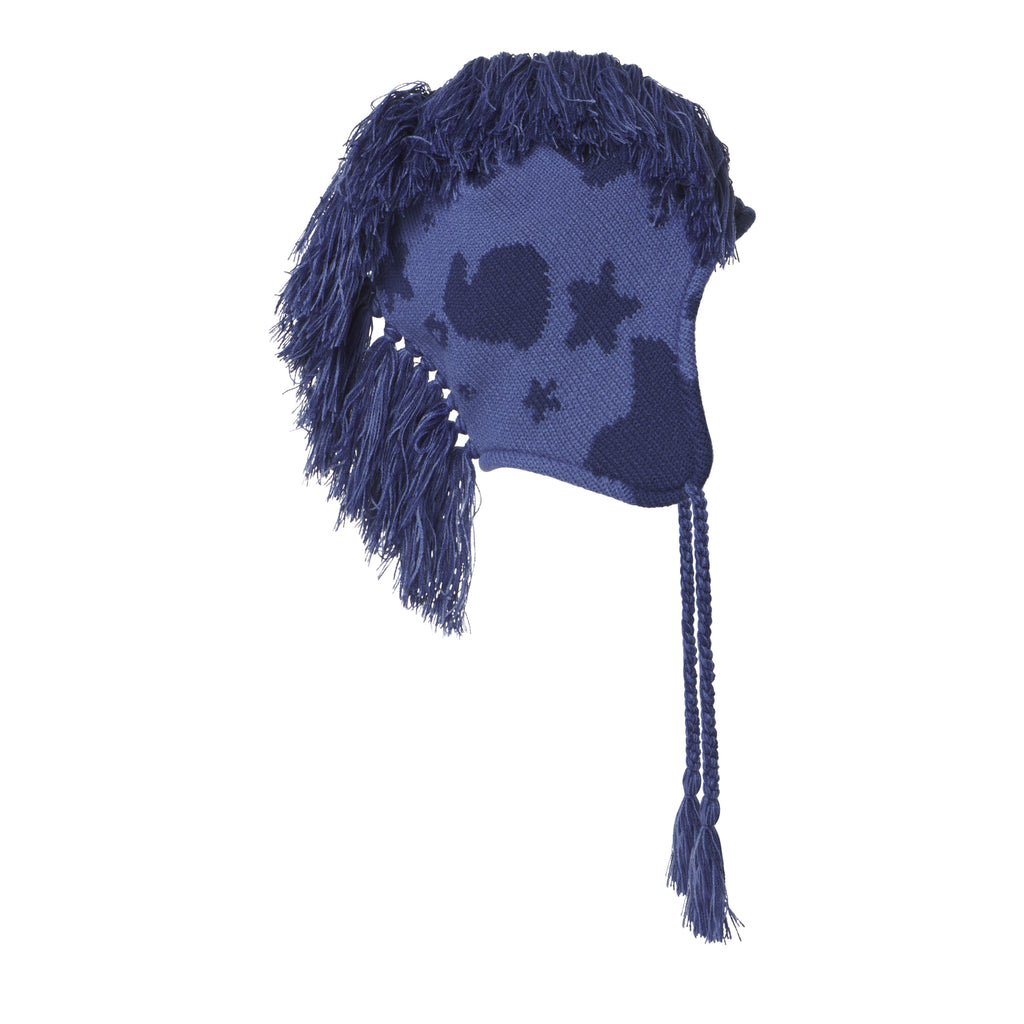 Blue knit hat with a beluga graphic print, mohawk fringe detail, ear flaps, and braided tie cord tassels.
