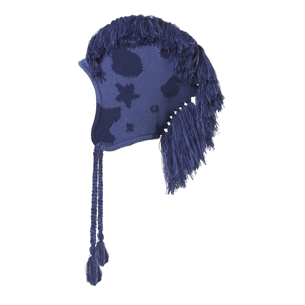 Blue knit hat with a beluga graphic print, mohawk fringe crown, and ear flaps with braided tie cord tassels.