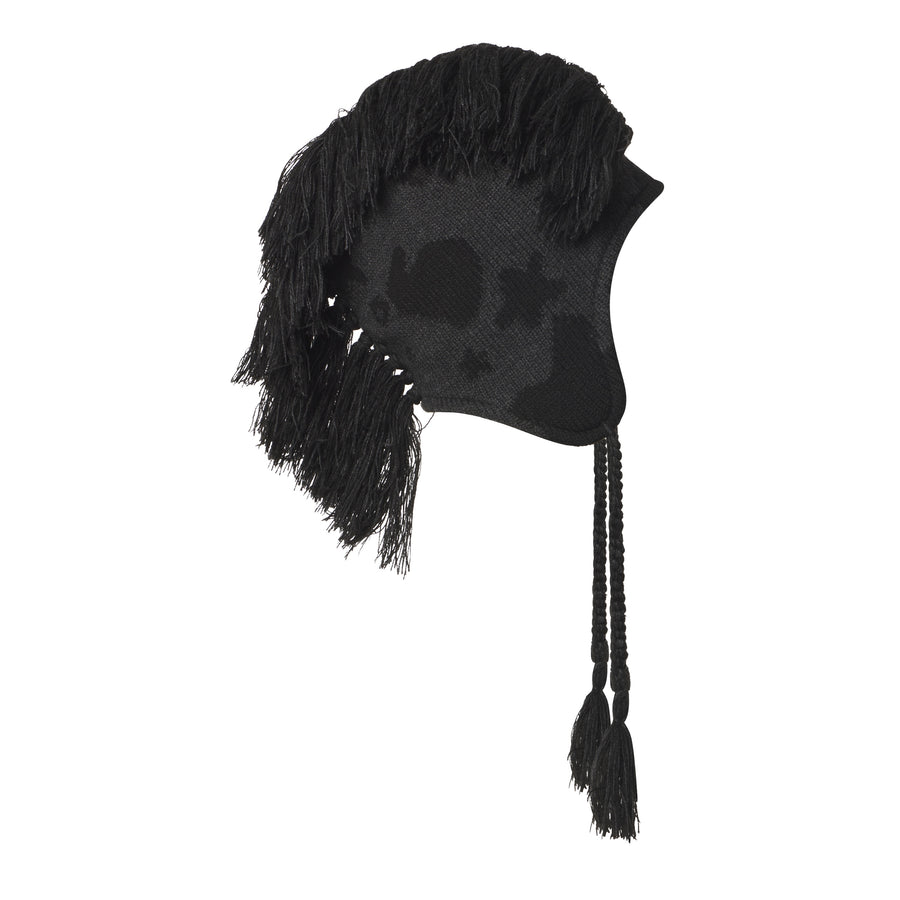 Black knit hat with a beluga graphic print, mohawk fringe detail, and braided ear flaps with tassels.