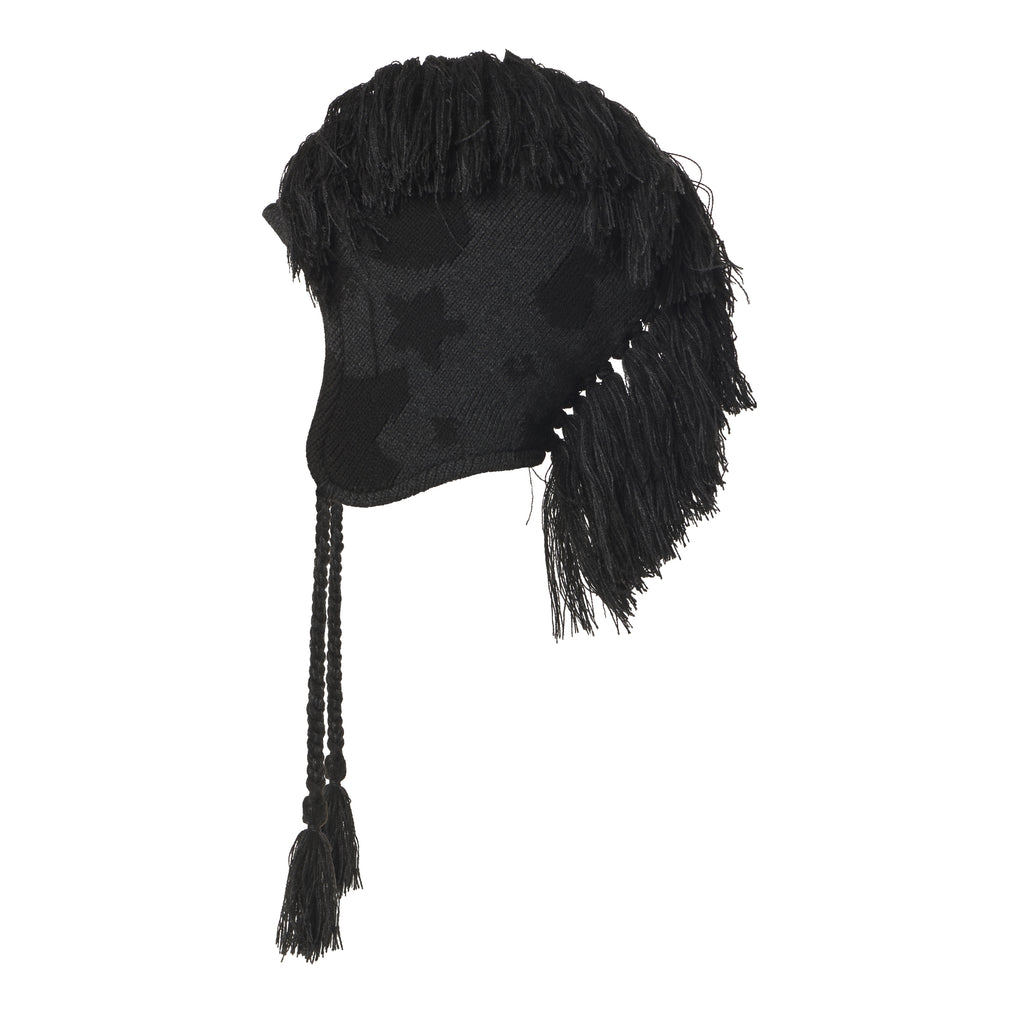 Black knit hat with a beluga graphic print, mohawk fringe crown, and ear flaps with braided tie cord tassels.