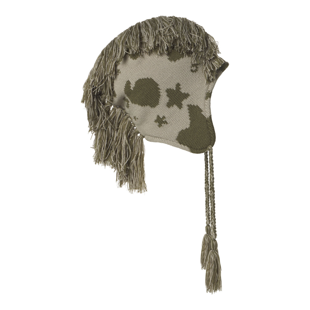 Beige knit hat with olive green beluga graphic print, mohawk fringe detail, and ear flaps with braided tie tassels.
