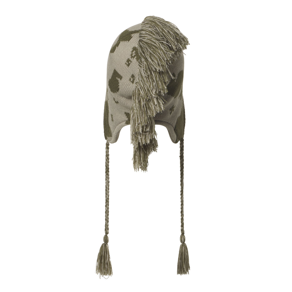 Olive and beige knit hat with a beluga graphic print, mohawk fringe detail, ear flaps, and braided tie cord tassels.