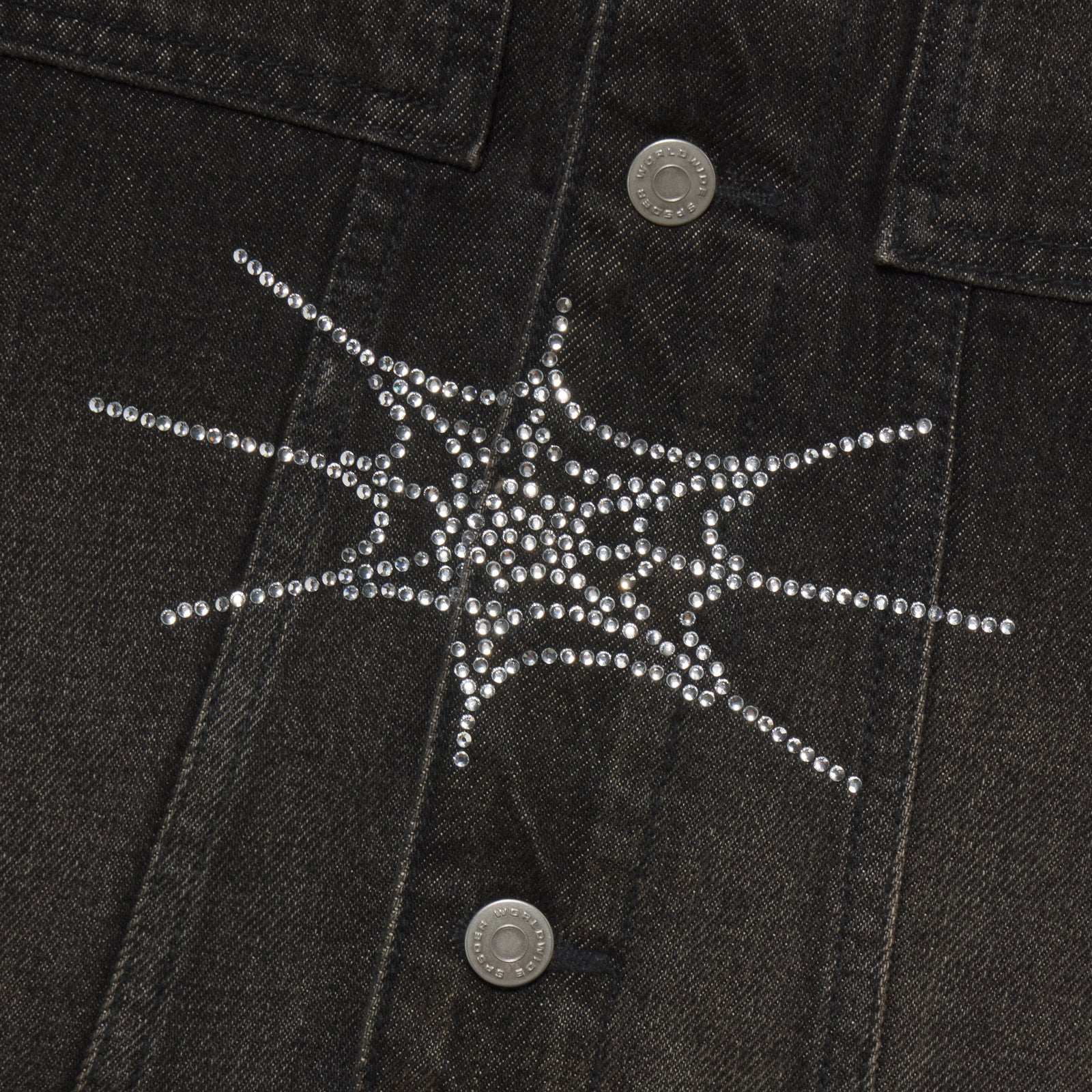 Black denim jacket featuring a sparkling rhinestone web graphic design and silver button closures.