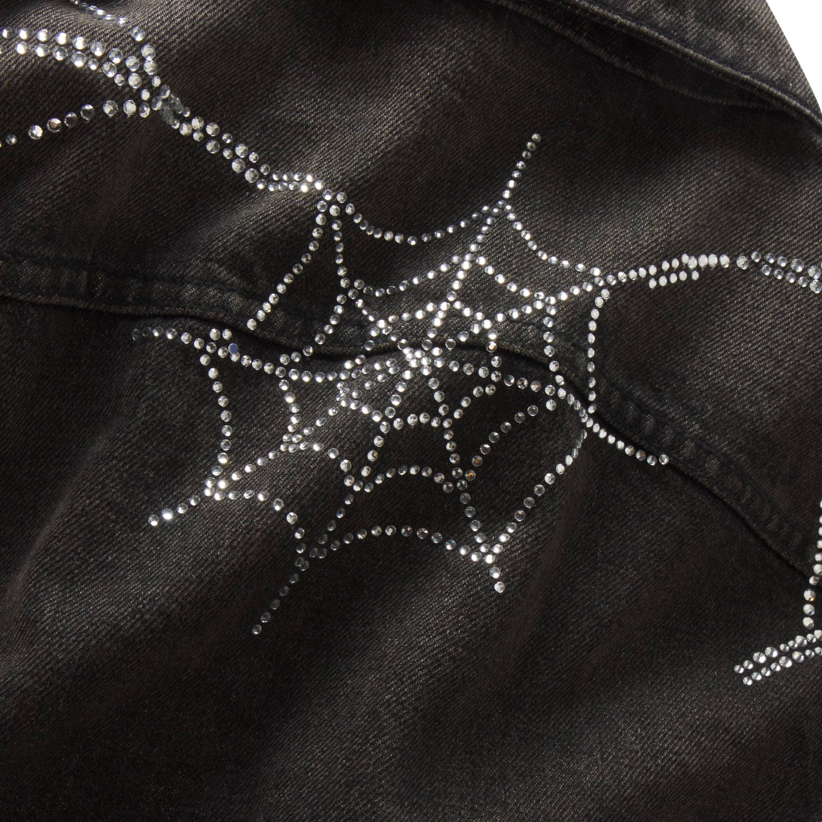 Black denim jacket featuring a sparkling rhinestone spider web graphic print design.