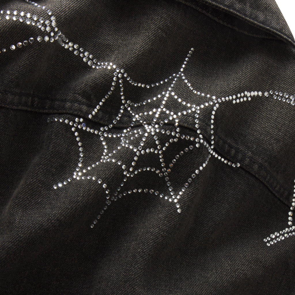 Black denim jacket featuring a sparkling rhinestone spider web graphic print design.