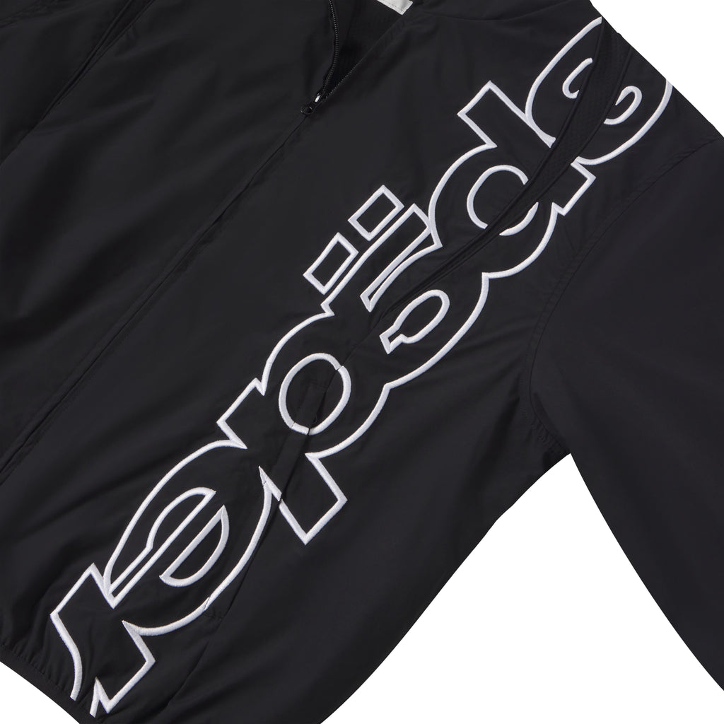 Black nylon track jacket featuring a white embroidered graphic design on the front with a full zip closure.