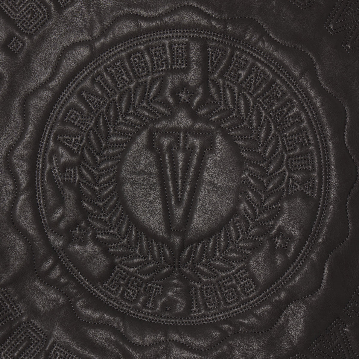 Black faux leather jacket featuring a tonal circular graphic design with embossed SP5DER branding and intricate stitching.