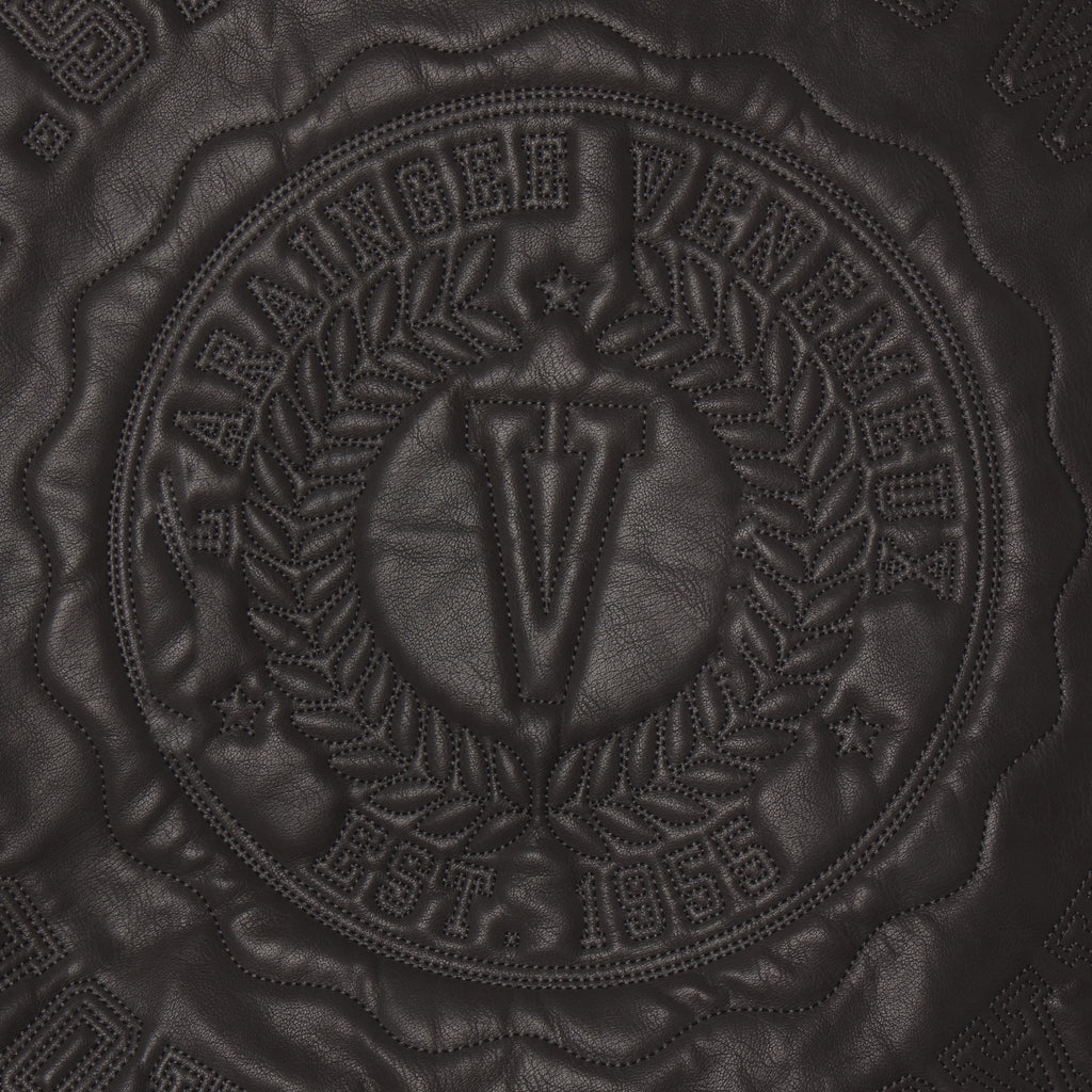 Black faux leather jacket featuring a tonal circular graphic design with embossed SP5DER branding and intricate stitching.