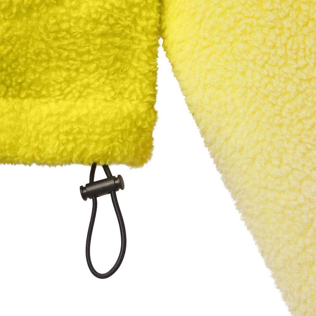 Bright yellow oversized fleece jacket with a textured finish and an adjustable black drawcord hem.