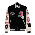 Black wool varsity jacket with cream leather sleeves, pink and black patches, and striped ribbed trim.