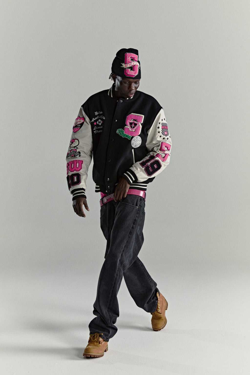 DIVISION 5 Varsity Jacket: Black wool body, white leather sleeves with pink debossed web design, embroidered patches.