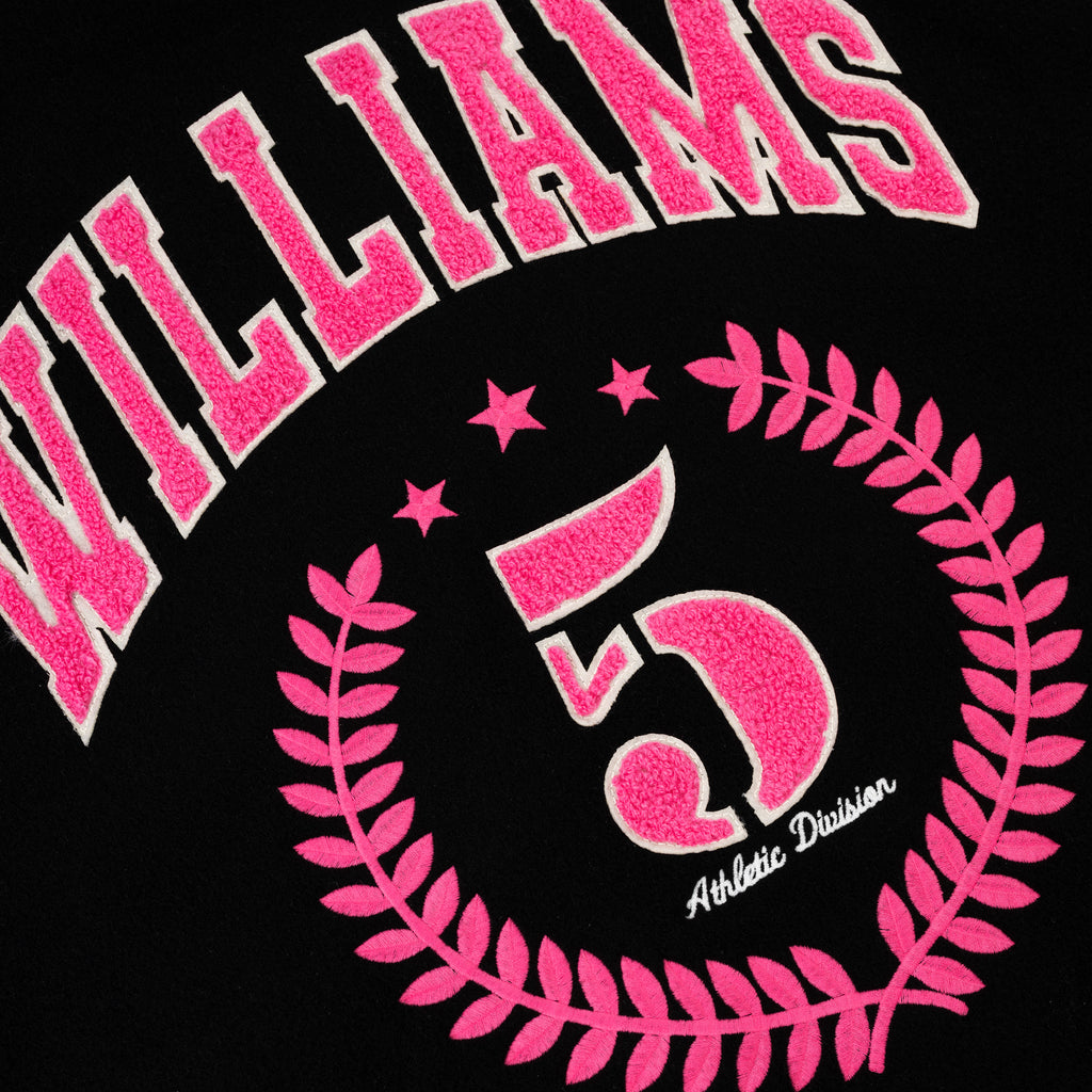 Black varsity jacket with pink "WILLIAMS" lettering, "5" in a laurel wreath, and "Athletic Division" embroidery.
