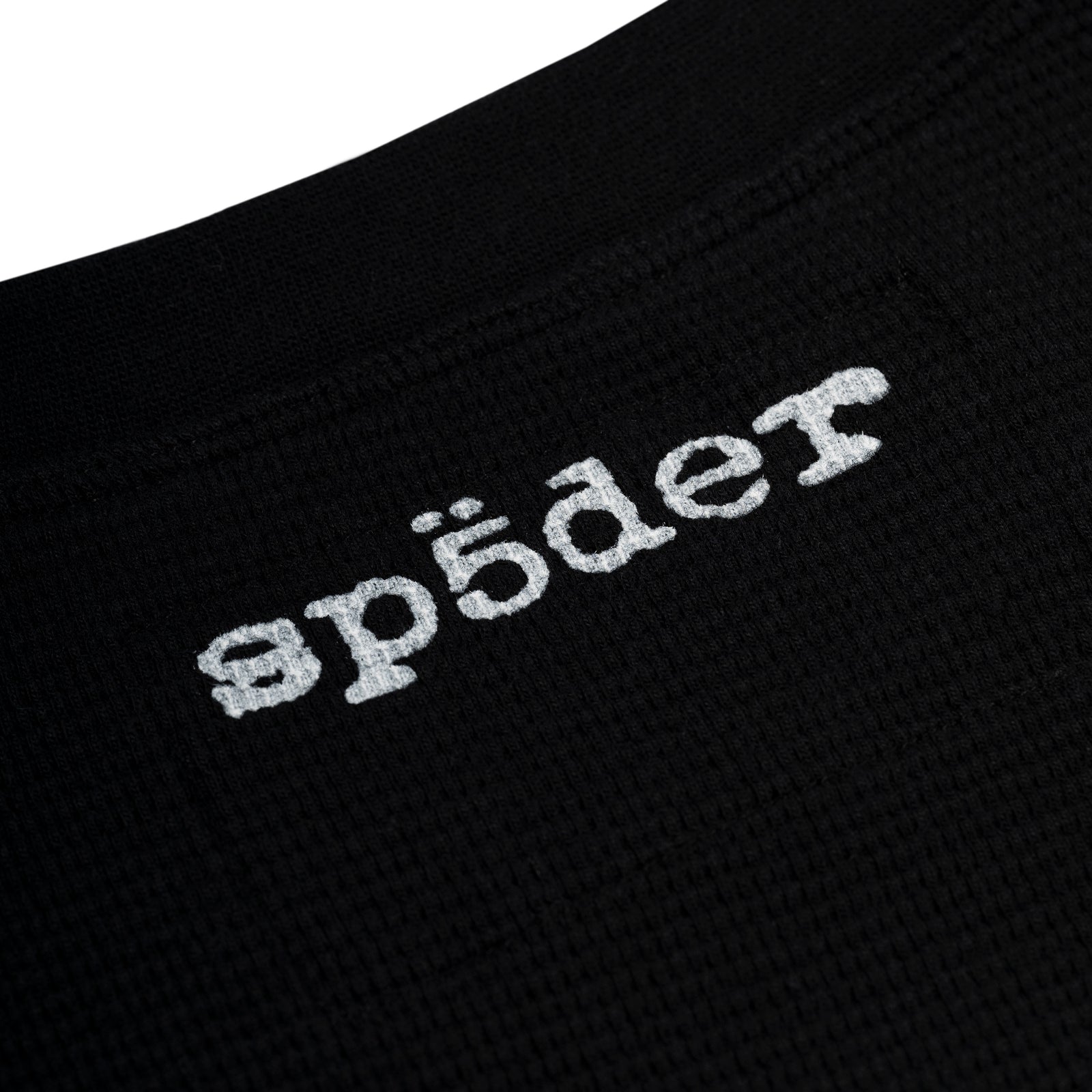 Black waffle knit thermal with white "ap5der" graphic print on the back neck.