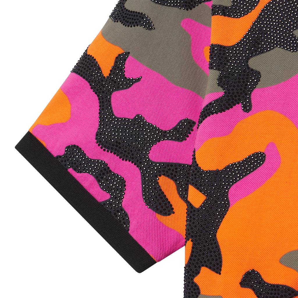 Cotton polo shirt featuring a pink, orange, and grey camo graphic print with sparkling rhinestone embellishments.