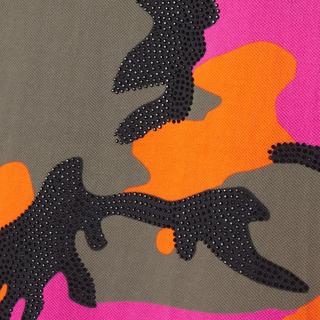 Cotton polo fabric featuring a pink, orange, and grey camo graphic print with black rhinestone embellishments.