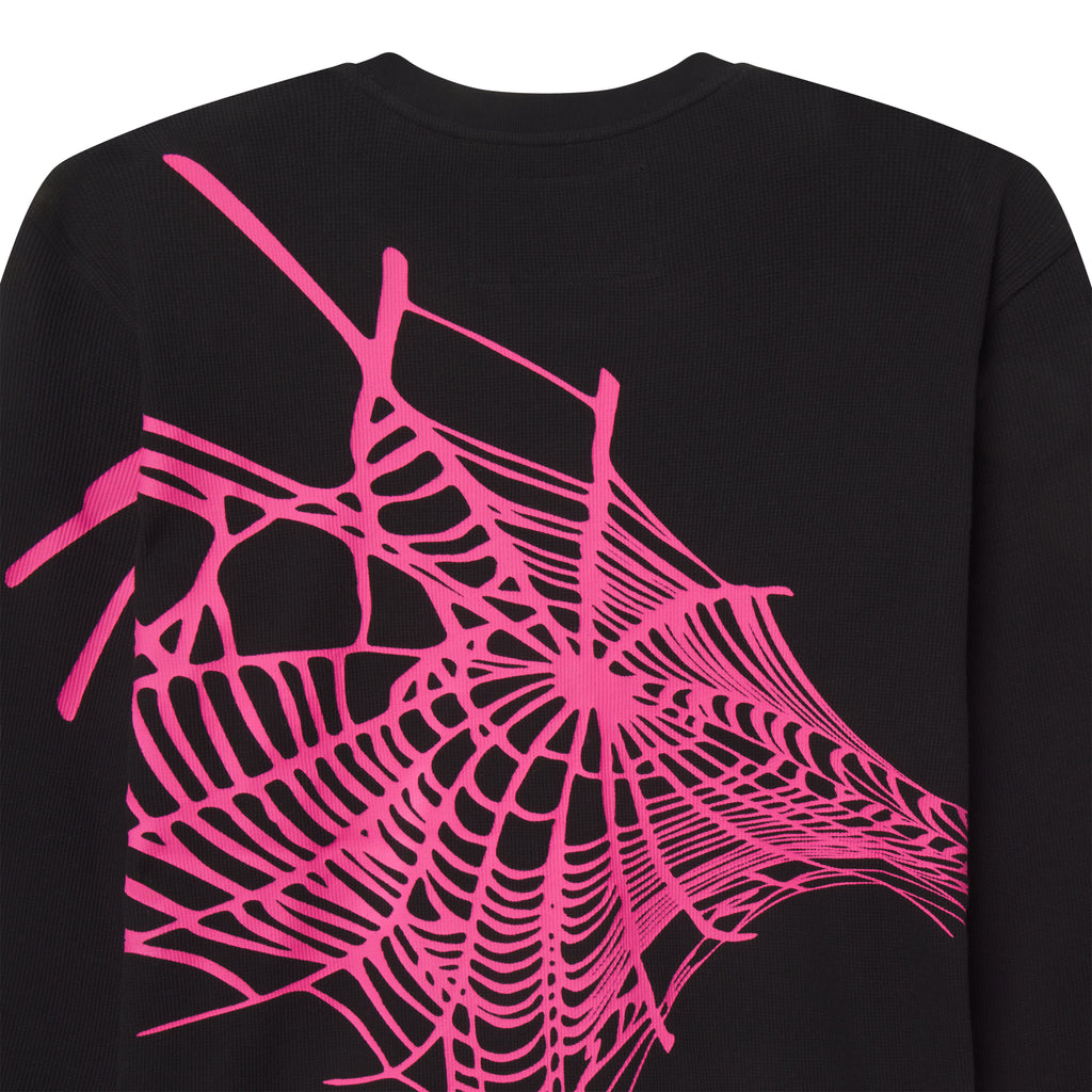 Black waffle knit thermal shirt featuring a vibrant pink spiderweb graphic print on the back and ribbed collar.