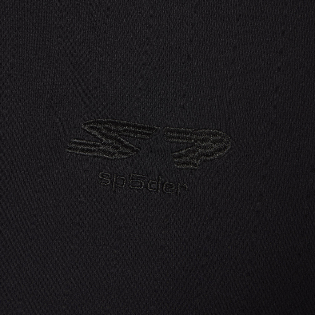 Black polyester SP5DER FOOTBALL JERSEY with reflective SP5DER graphic design at front.