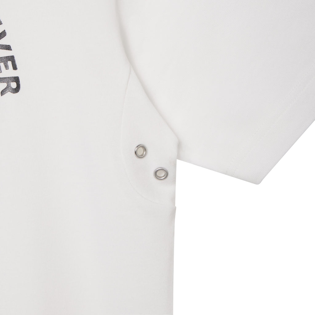 White cotton tee featuring a graphic print and two silver-tone metal eyelets at the underarm.