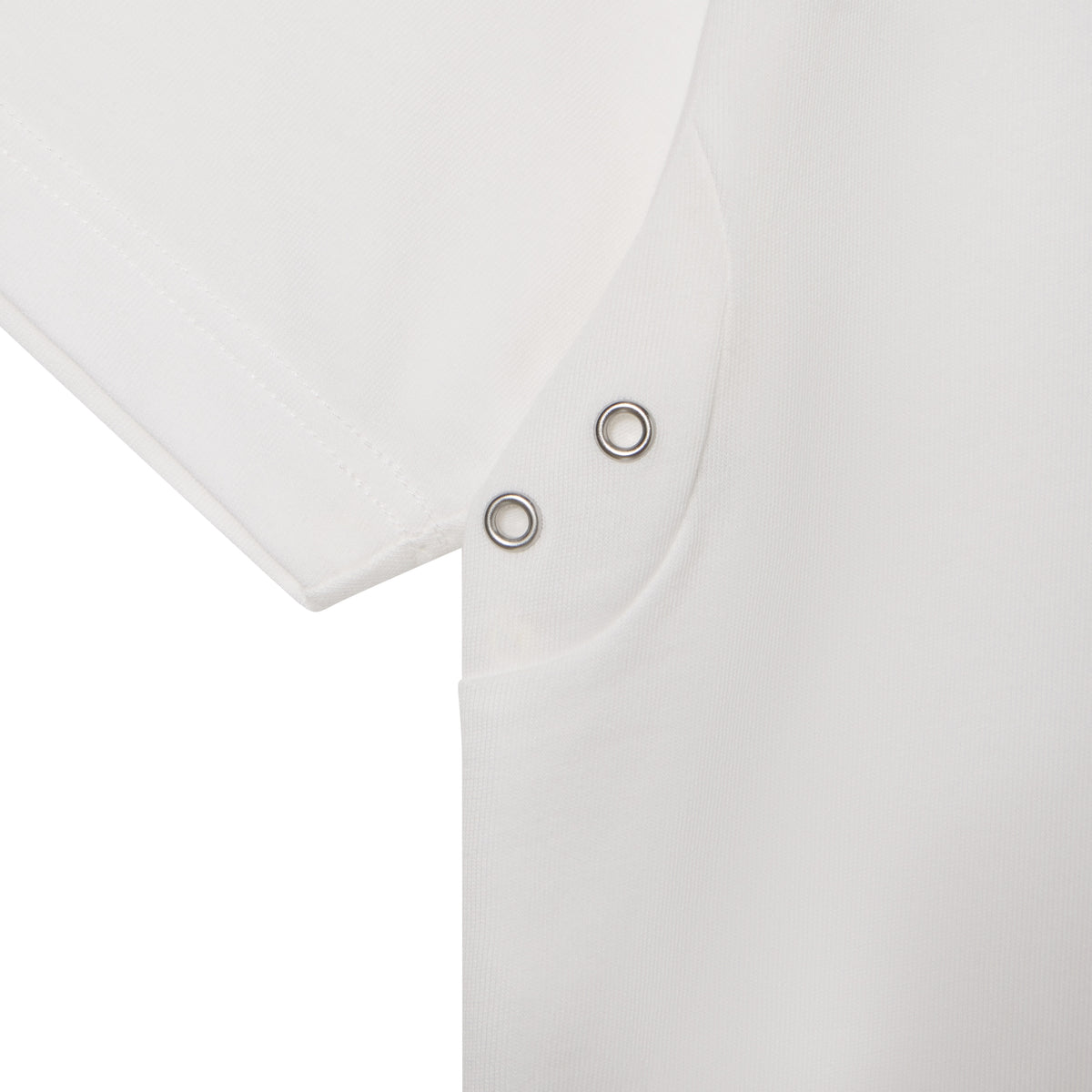 White 100% cotton t-shirt featuring two silver-tone metal eyelets at the underarm seam.