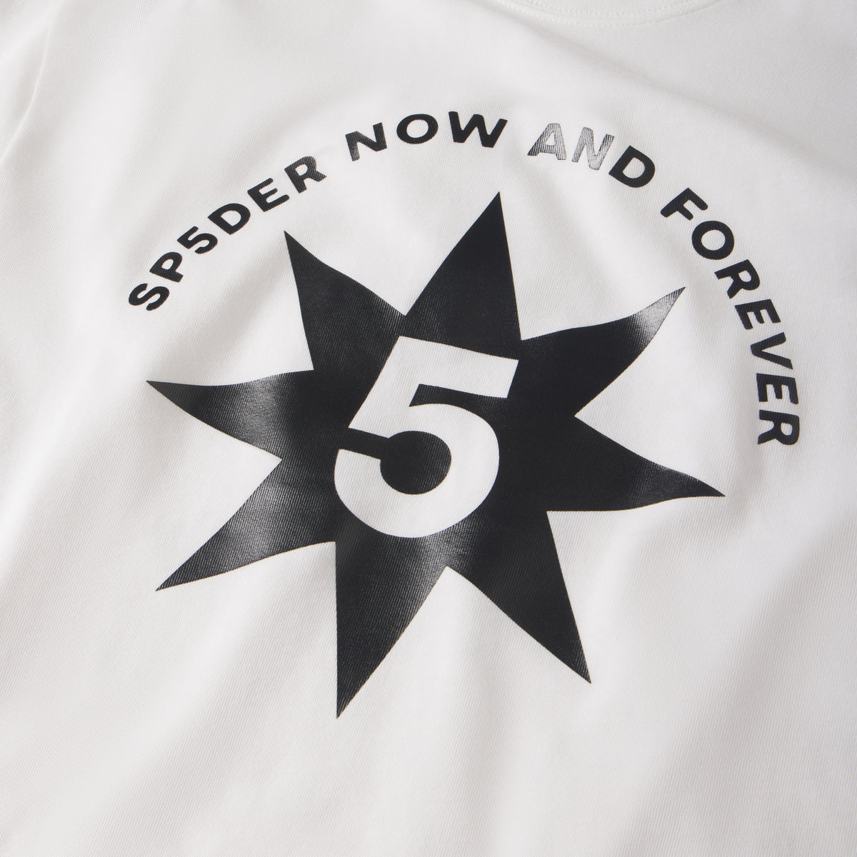 White 100% cotton tee featuring a black star graphic print with a white number 5 and SP5DER NOW AND FOREVER text.