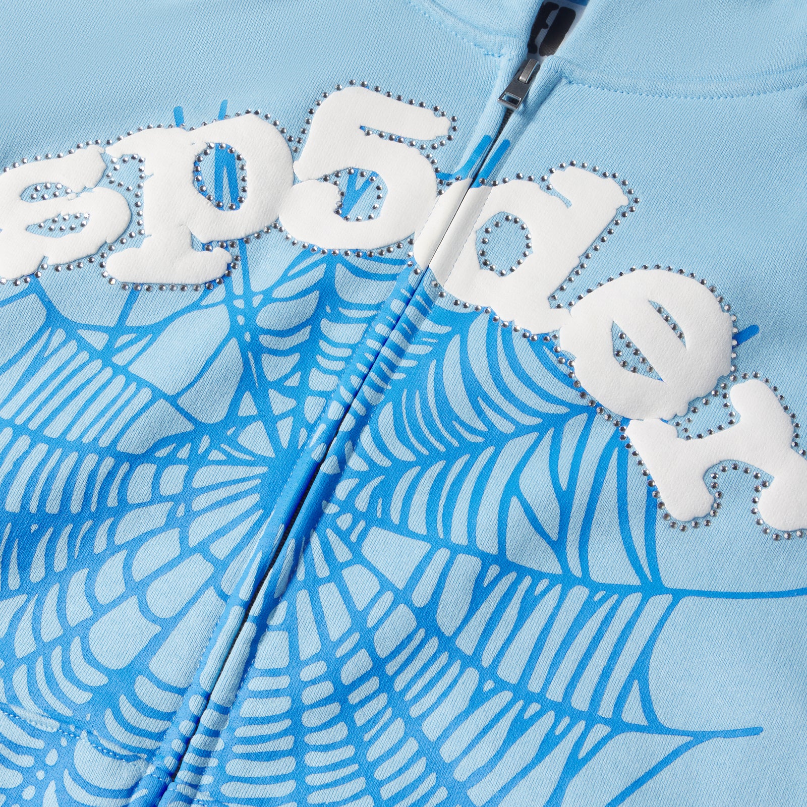 Light blue cotton fleece zip-up hoodie with white puff print "sp5der" and blue spider web design.
